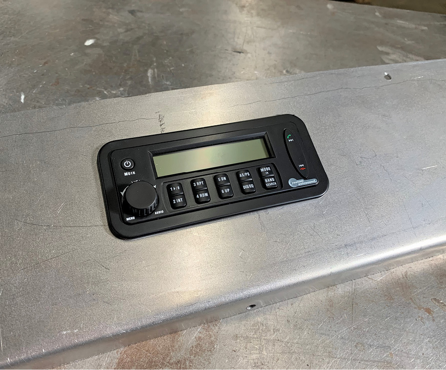 Finally, the Custom Autosound head unit can be installed in the dash. A rectangular hole is cut with notches on each side, which allow it to snap into place.