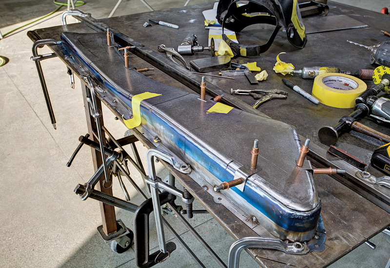 The front surface and perimeter of the panel are built while the mounting flange is clamped securely to the workbench, keeping everything flat and true.