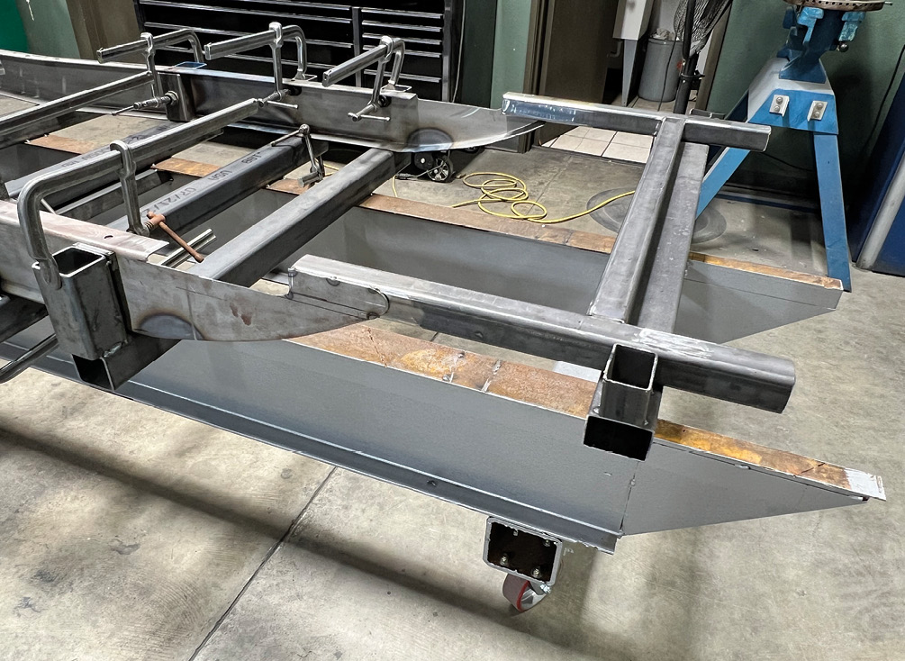 This section will constitute not only the rearmost body mounting locations, but also function as the rear spring crossmember.