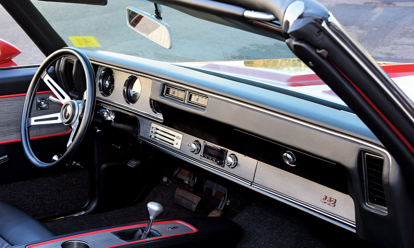 focused view, with the top down, of the ’70 Olds 4-4-2 convertible passenger side and driver dashboard and steering
