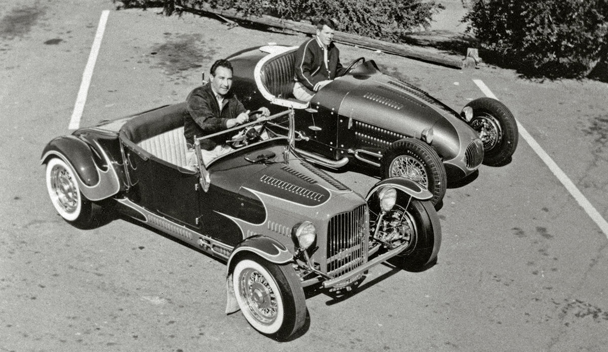 Black & white photograph of Oakland’s Frank Rose with his AMBR-winning ’27 T roadster in 1954, posed alongside Dick Kraft’s T roadster before the Oakland Roadster Show opening that year. Kraft, of course, made American hot-rodding history running his spare and dreadfully exposed “Bug” dragster at the first Santa Ana drags in 1950.