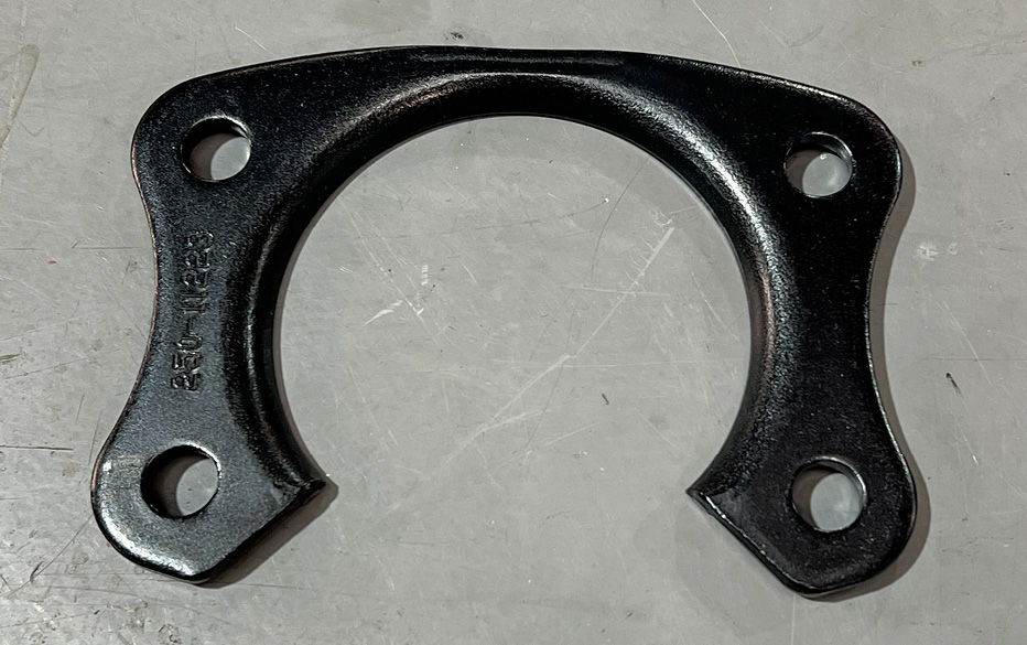 This is the axle retainer that attaches to the axle housing. The open end of the bracket allows it to be installed with the axle in place unlike the OEM full-circle design.