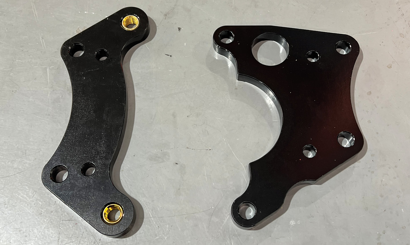These are the caliper mounting brackets, the hydraulic caliper bracket on the left, EPB bracket on the right.