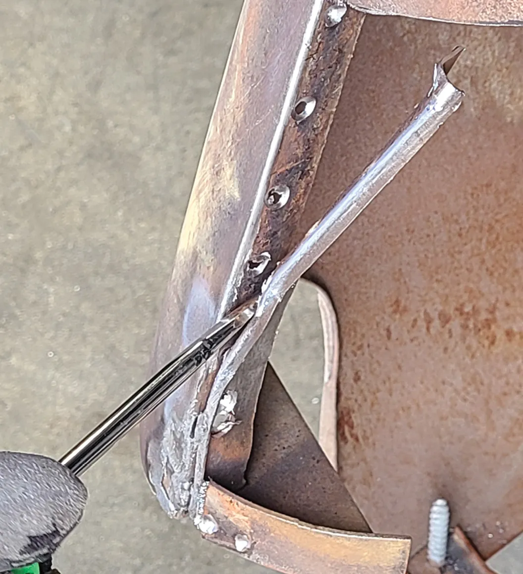Once drilled out the spot welds can be popped apart with a screwdriver or, in some cases, a pneumatic chisel.