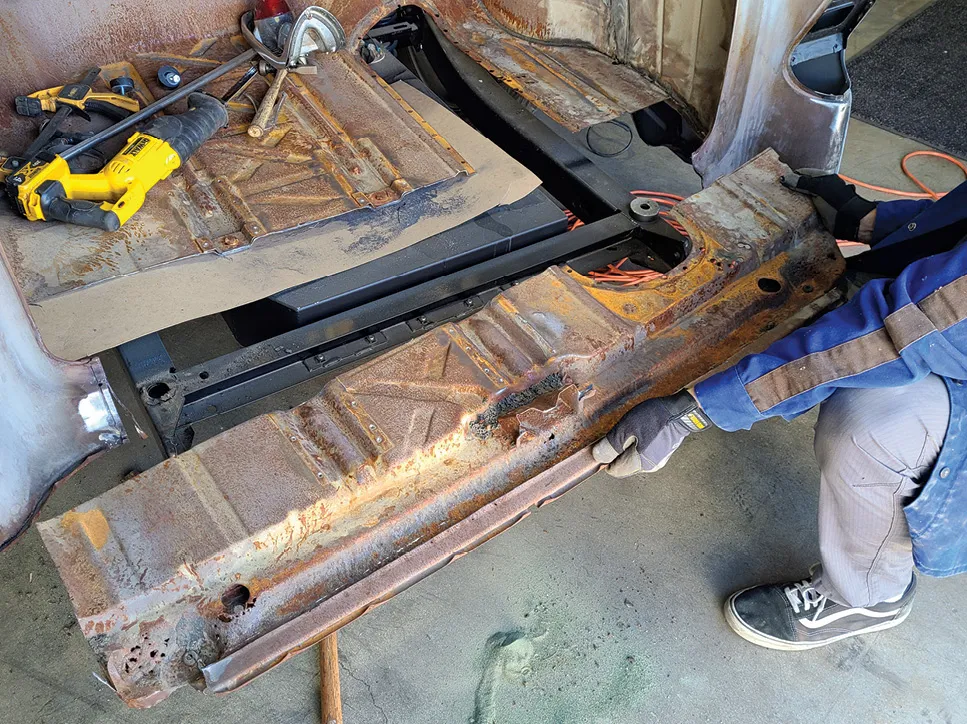 The new tailpan section was laid inside the trunk to help define the cutline and, with a piece of cardboard shoved up between the aftermarket gas tank and the floor, Hamusek makes a rough cut and removes the old tailpan.