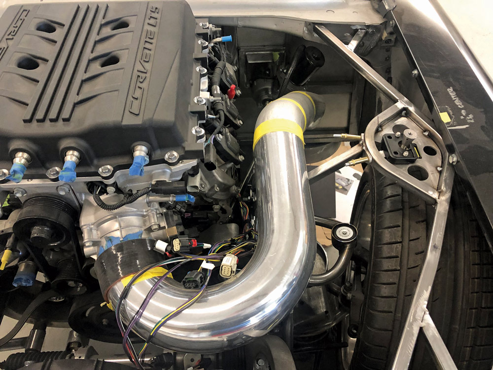 You’ll notice the custom fender supports built out of square tubing. This ties into the radiator support, while custom lower fender supports extend from the framerails.