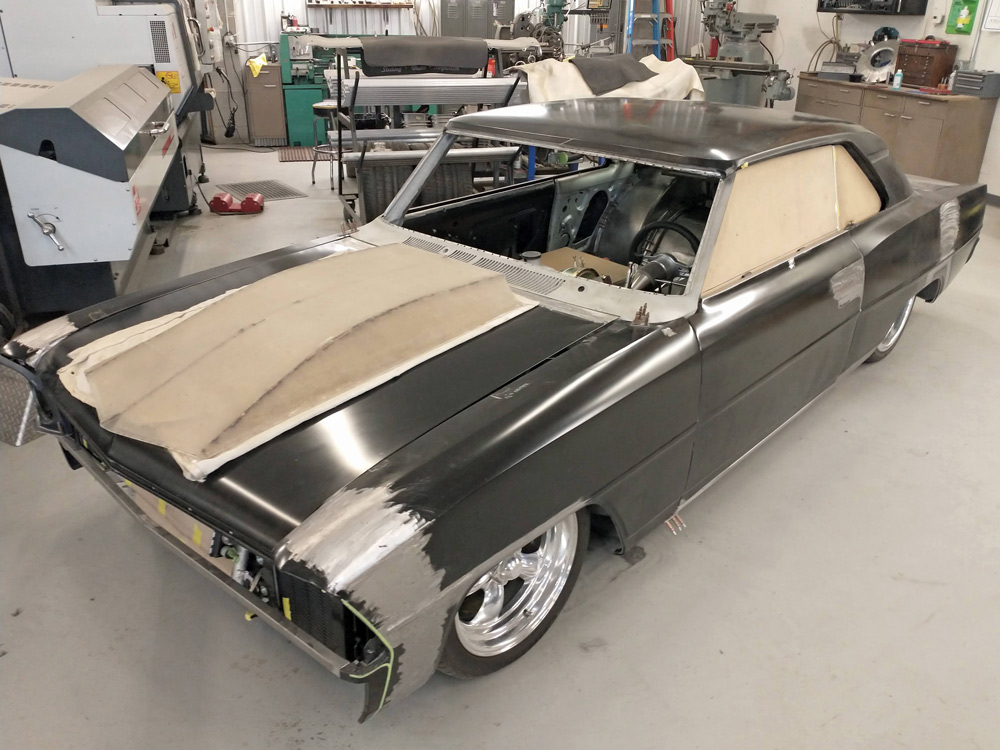 The Nova is sitting on the ground, showing off its slammed stance. The wheelbase adjustments, stretched front fenders, and custom hood treatment give this ’67 Nova a new attitude, thanks to high-end fabrication from the crew at DSR and a custom chassis from AME.