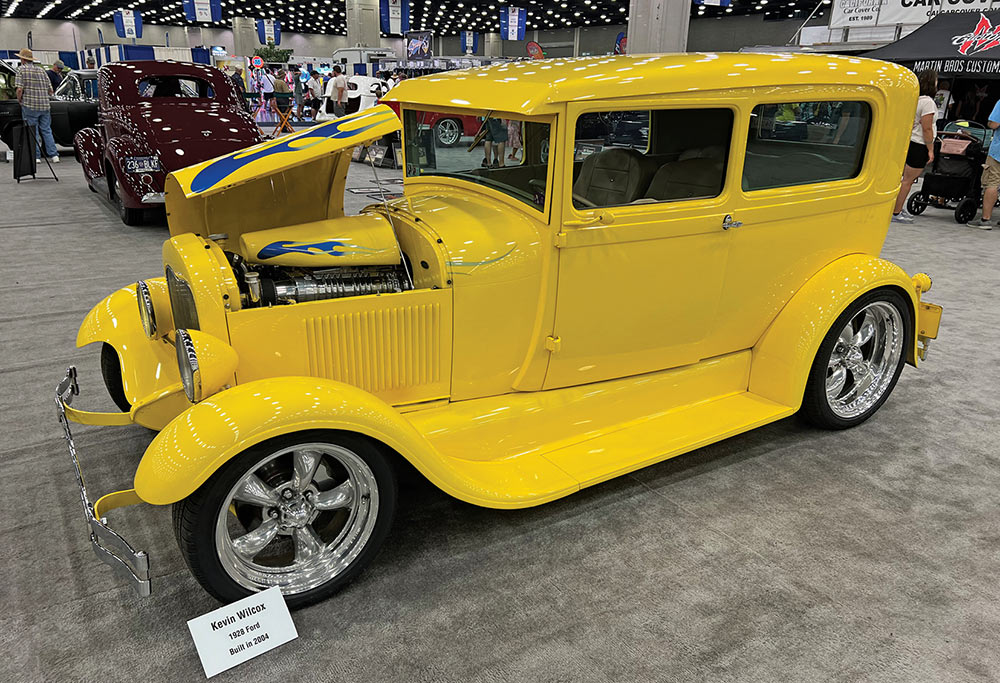 Yellow '28 Ford sedan with blue hood flames