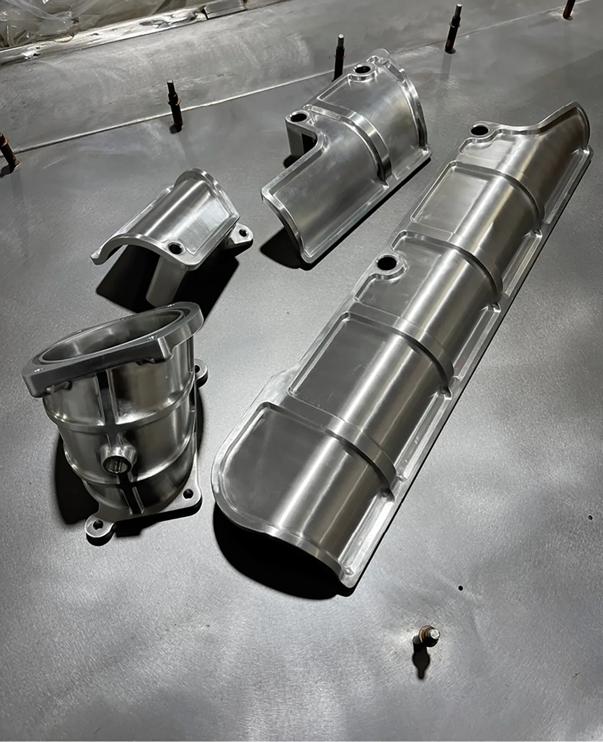 These are the final components just after being machined from aluminum billet.