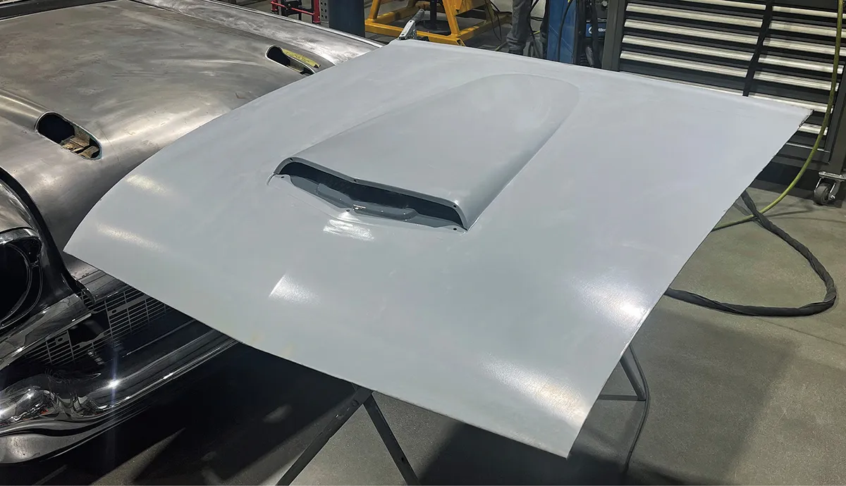 A coat of primer is used to seal the hood, top side, and bottom.