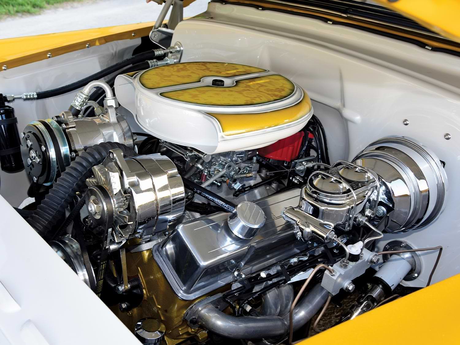 view of the custom ’54 Chevy Bel Air's engine styled with custom painted covers and components