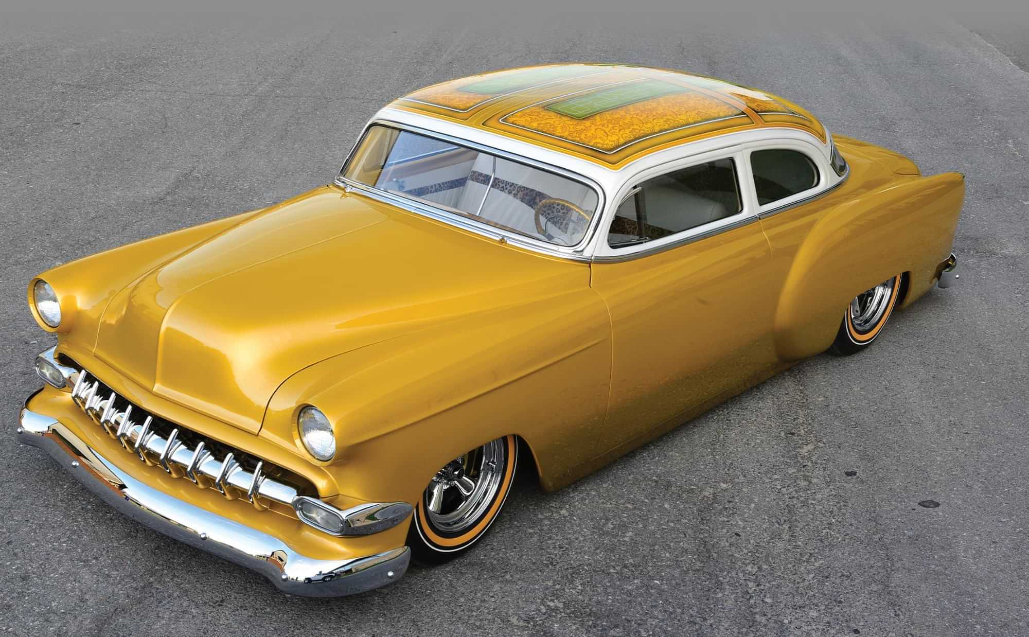 high angle 3/4ths driver side view of the John Hall Jr.'s gold custom ’54 Chevy Bel Air