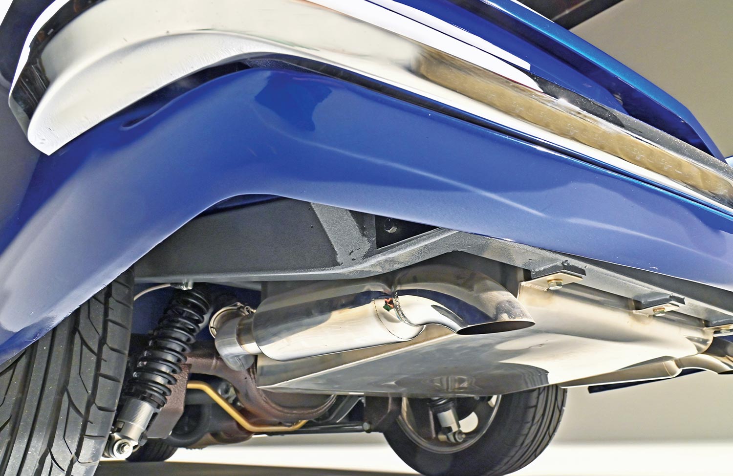 worm's eye angled view of ’55 Thunderbird convertible's rear undercarriage