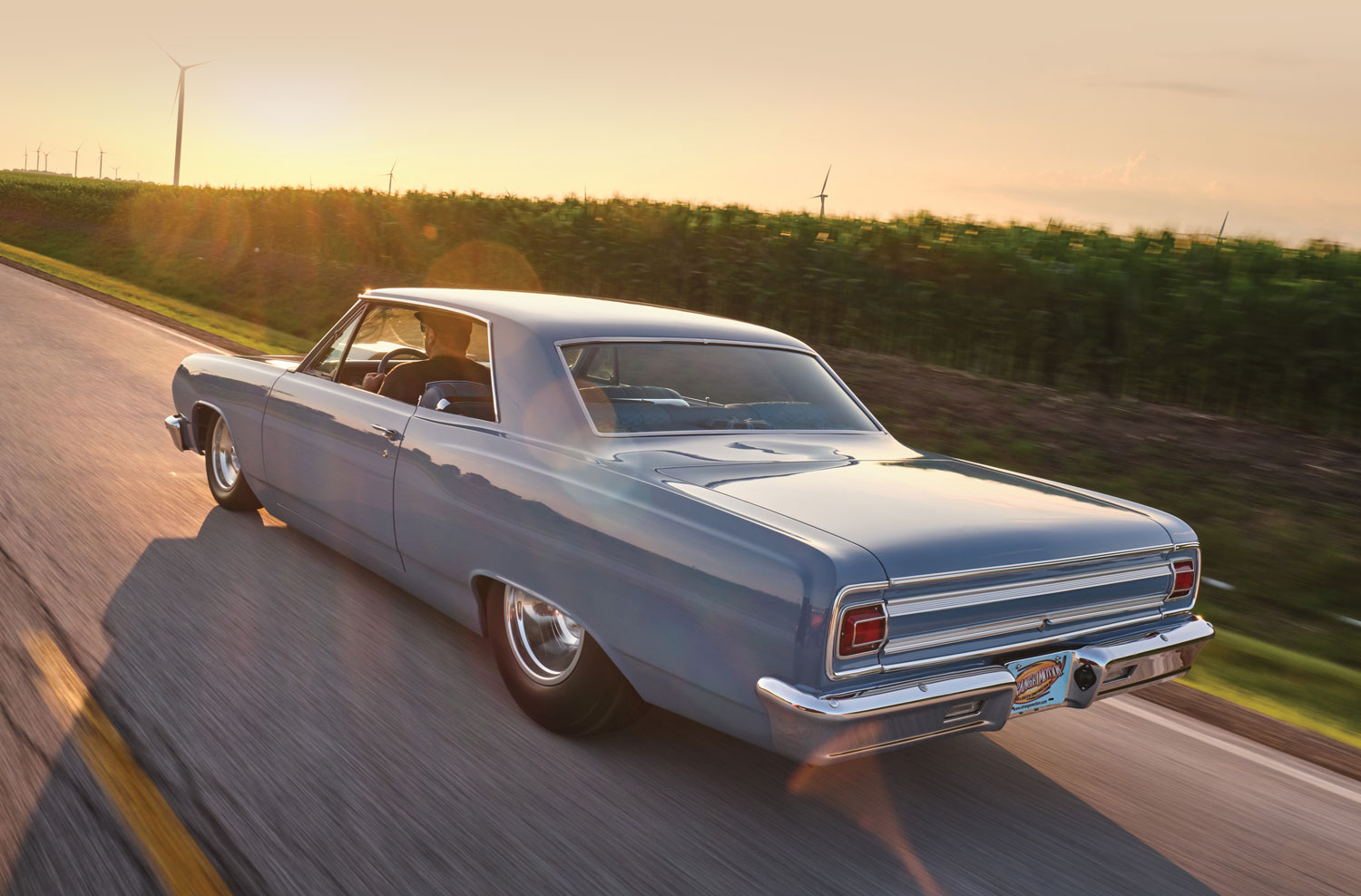 ’65 Chevelle driving towards a sunset