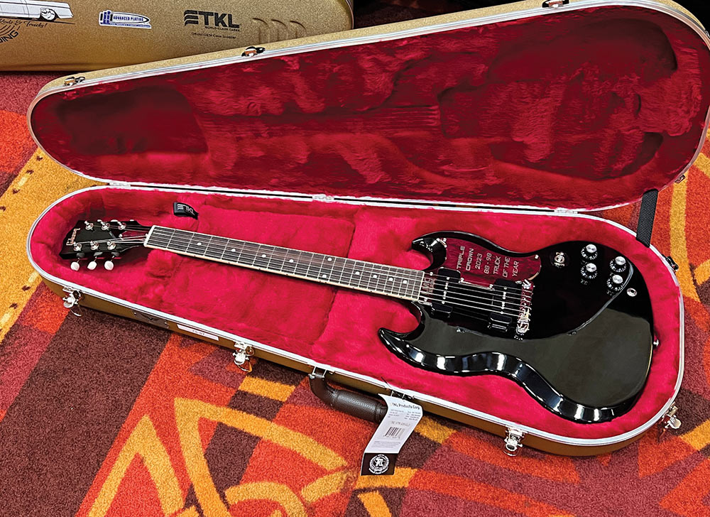 Black Gibson SG in red lined case