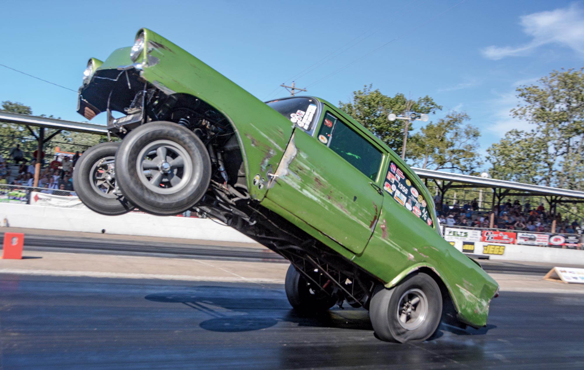 Mike Bilina’s green ‘56 Chevy with the front wheels in the air