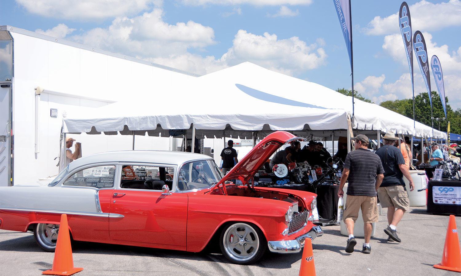 A red and white chevy in front of a vendor tent