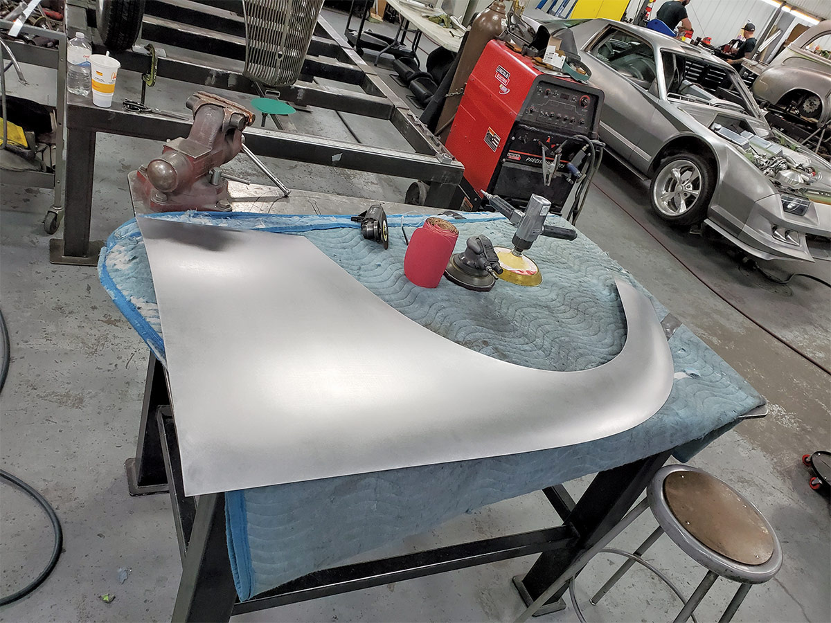 new quarter-panel cut from steel laying on table