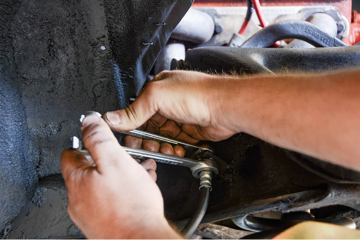 The hard lines are connected to the new rubber flex hoses, and new retaining clips are used to hold it in place.