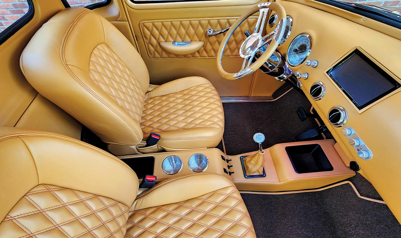 view from the passenger side window of the rusty orange ’50 Chevy Pickup's interior seating