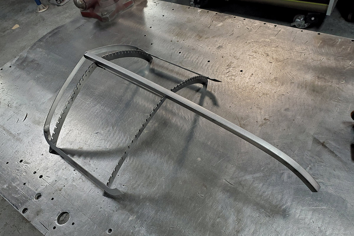 The frame of the grille starting to be assembled on a metal table