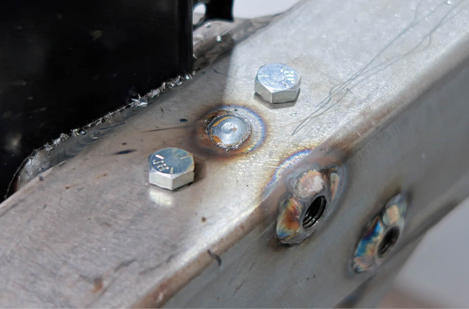 The reinforcement plates are held to the tops of the ’rails with rosette welds; the plates have threaded holes to accept the headlight brackets’ bolts.