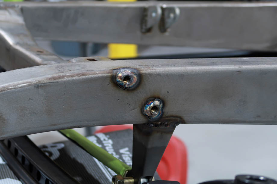 Here the shock mounting bungs have been welded in place. Mounted to the bottom of the frame is the bracket for the Speedway Motors Panhard bar.