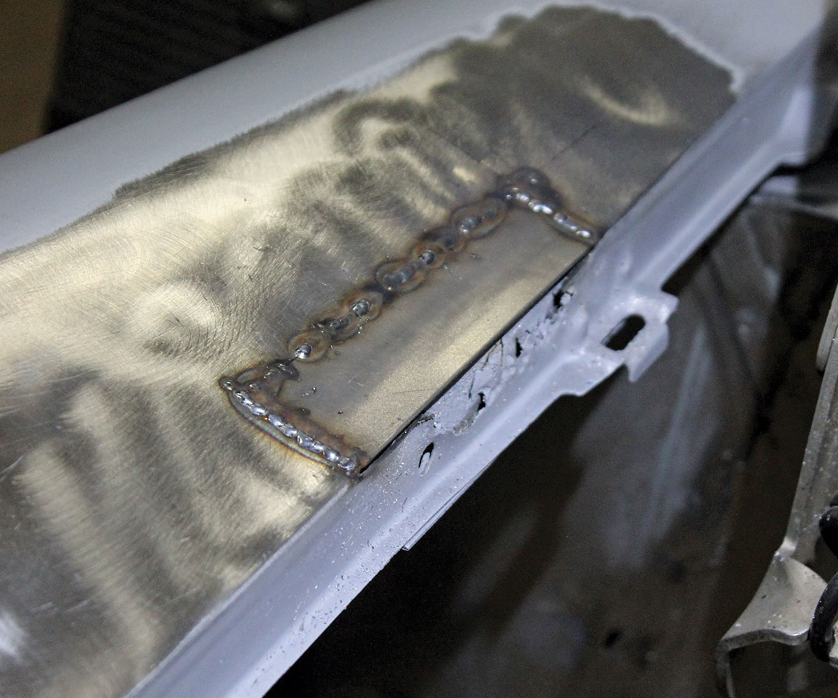 Close up of a small rectangular area welded onto the car