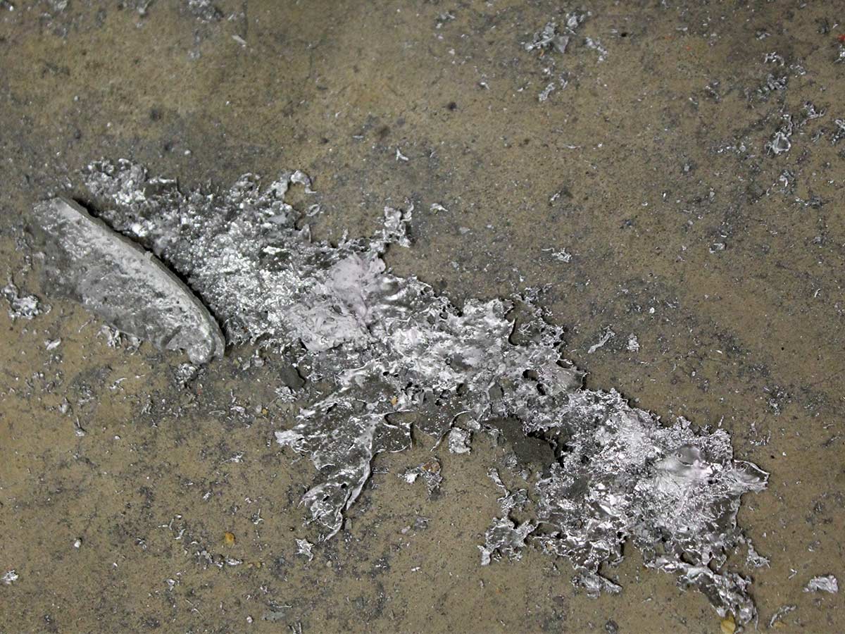Melted puddle of lead on the floor