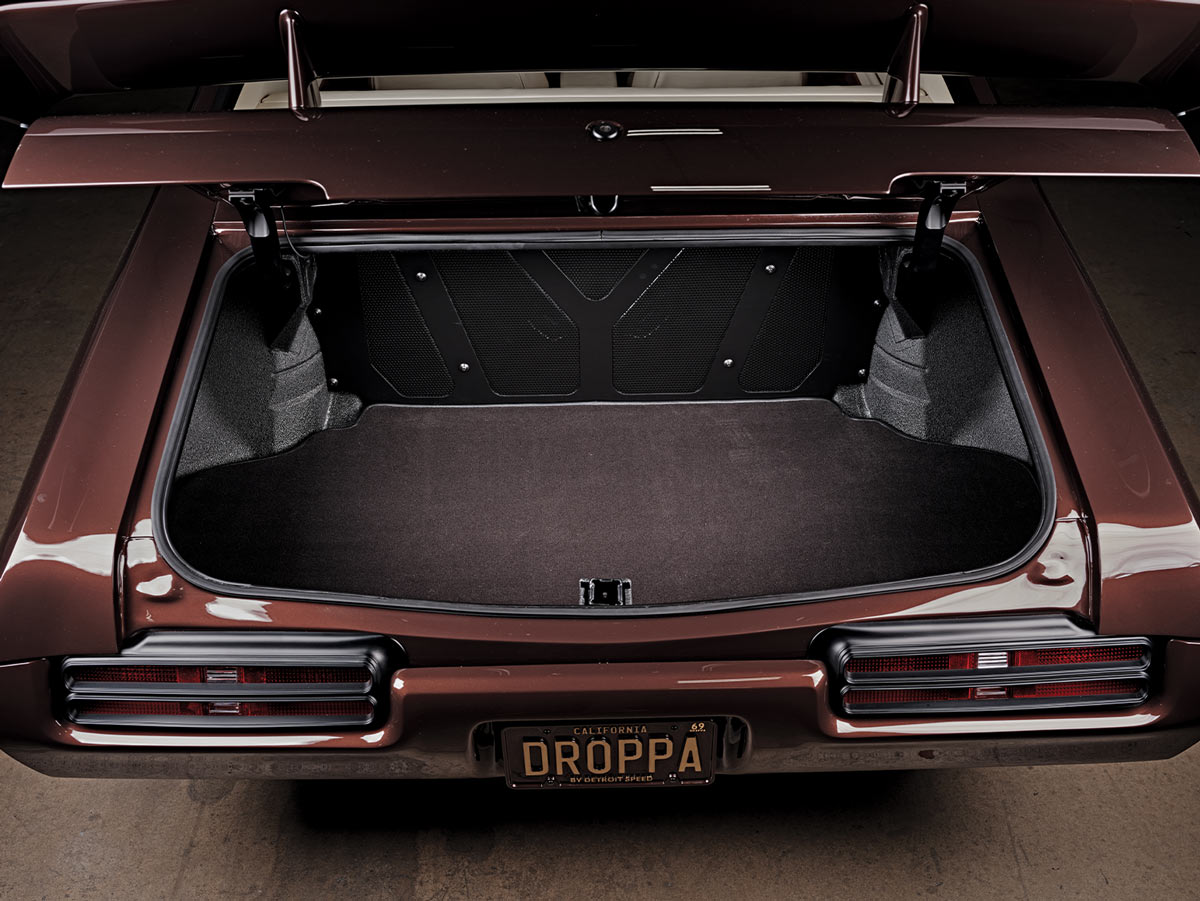 high angle view of the ’69 GTO's open trunk, below the California license plate reads: DROPPA