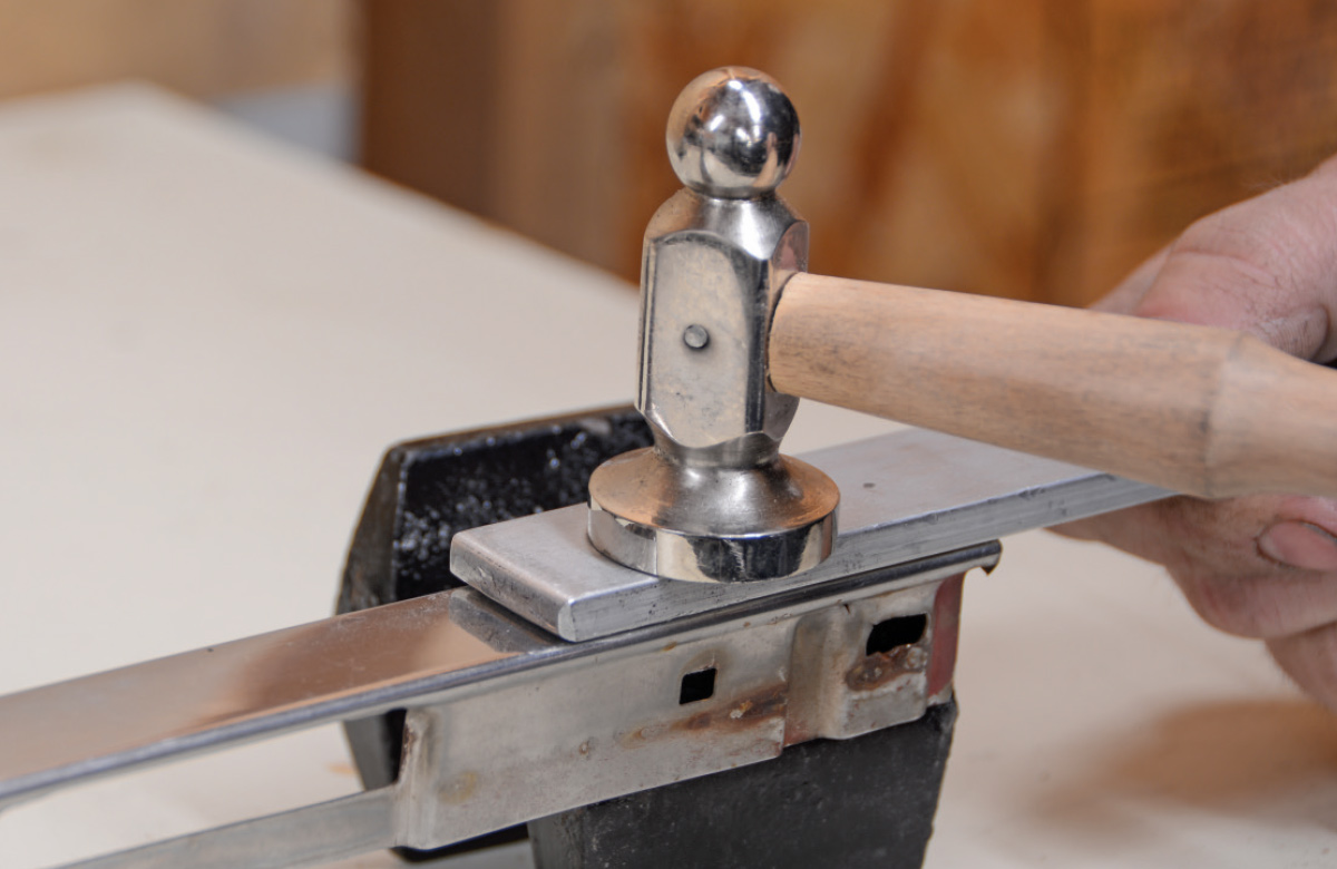 flat stock is used to transfer a blow from a hammer and spread the load across the entire area of the worked trim