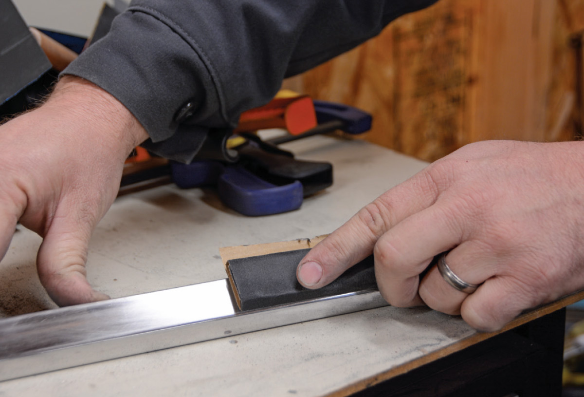 the trim piece sanding is continued with a higher grit sandpaper