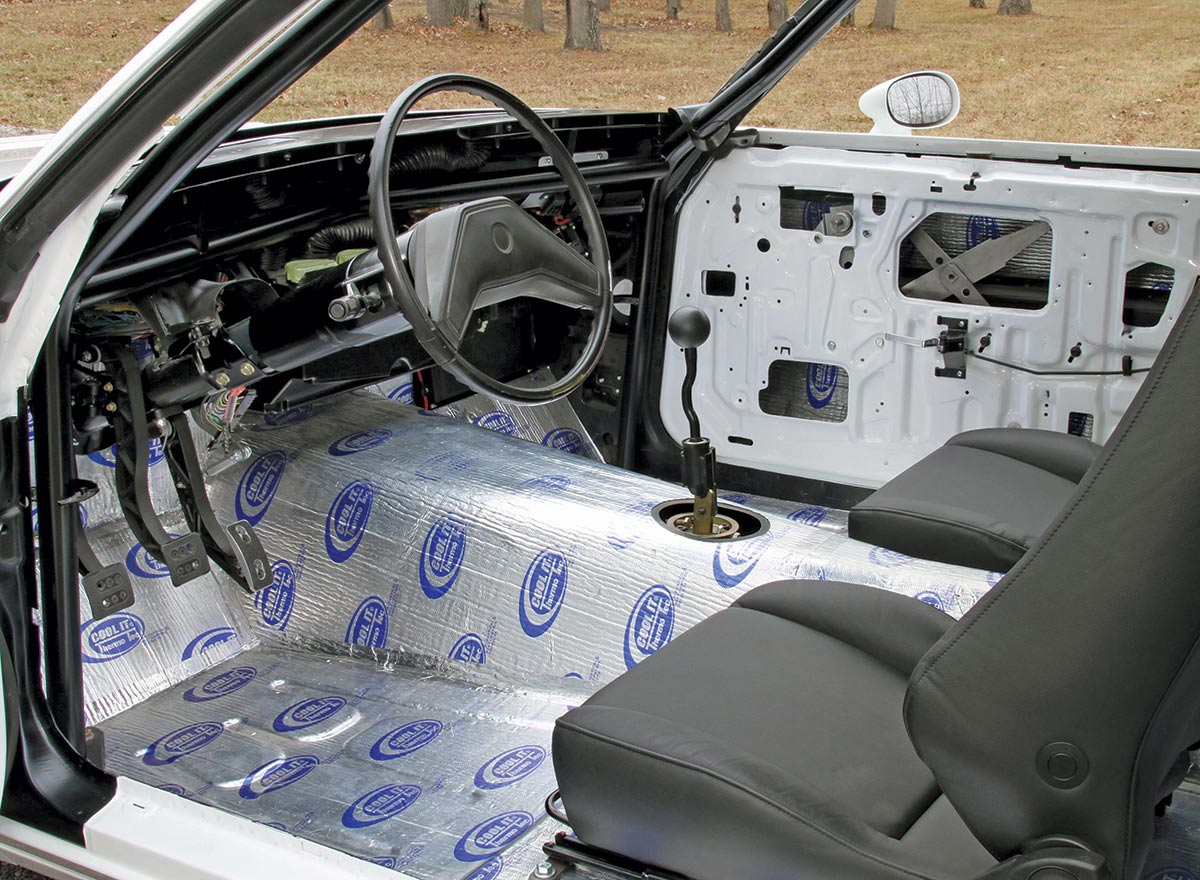 Landscape close-up angle view of the driver's seat area from the vintage 1987 Pontiac Grand Prix (Project: G-Force One) white car