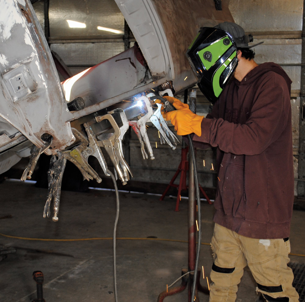 welder wearing a mask while using a torch