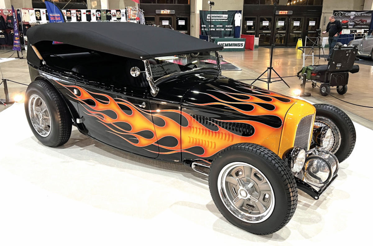 passenger side view of a black ’32 Ford phaeton with flames