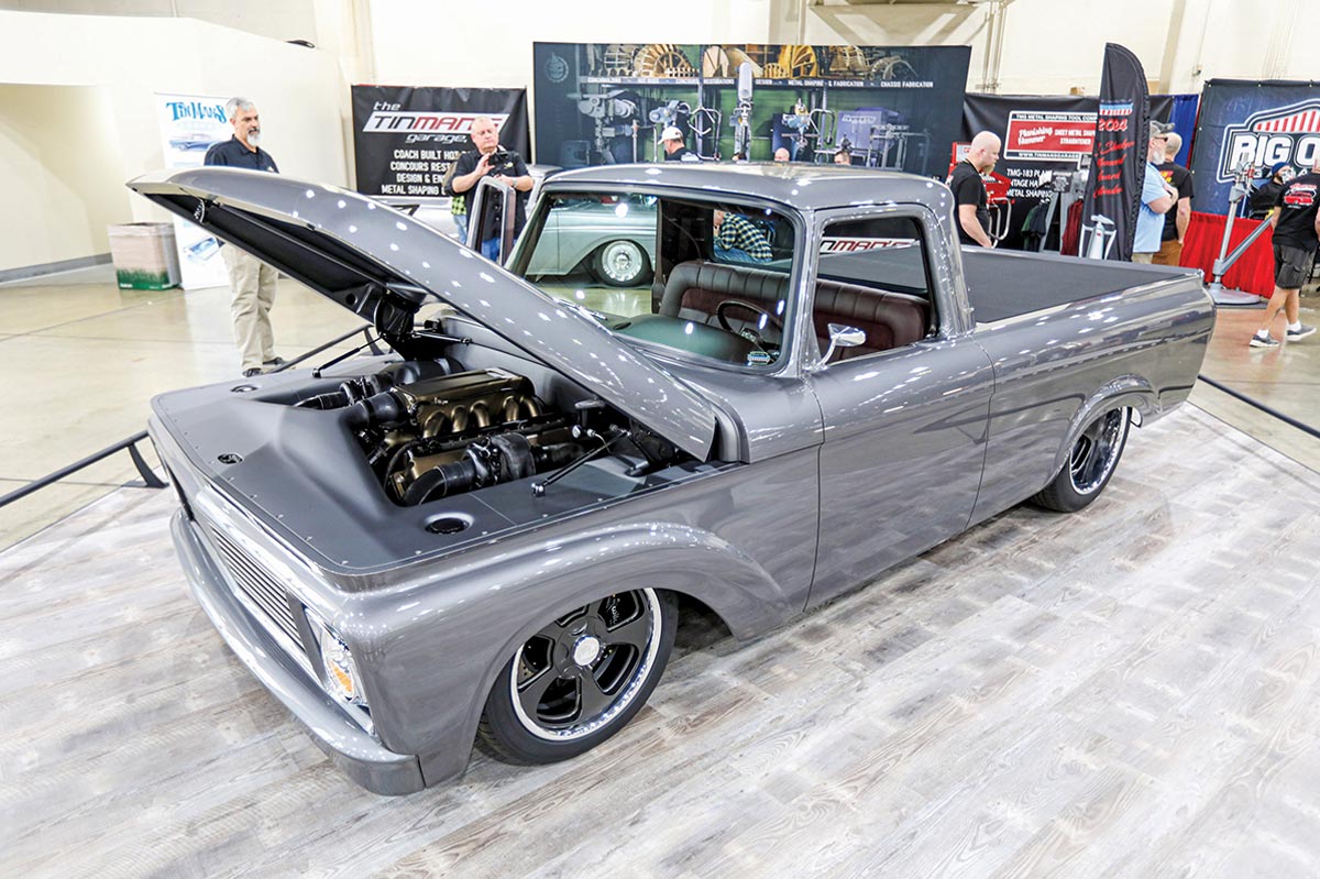 driver side of a silver ’61 Ford pickup with its hood lifted
