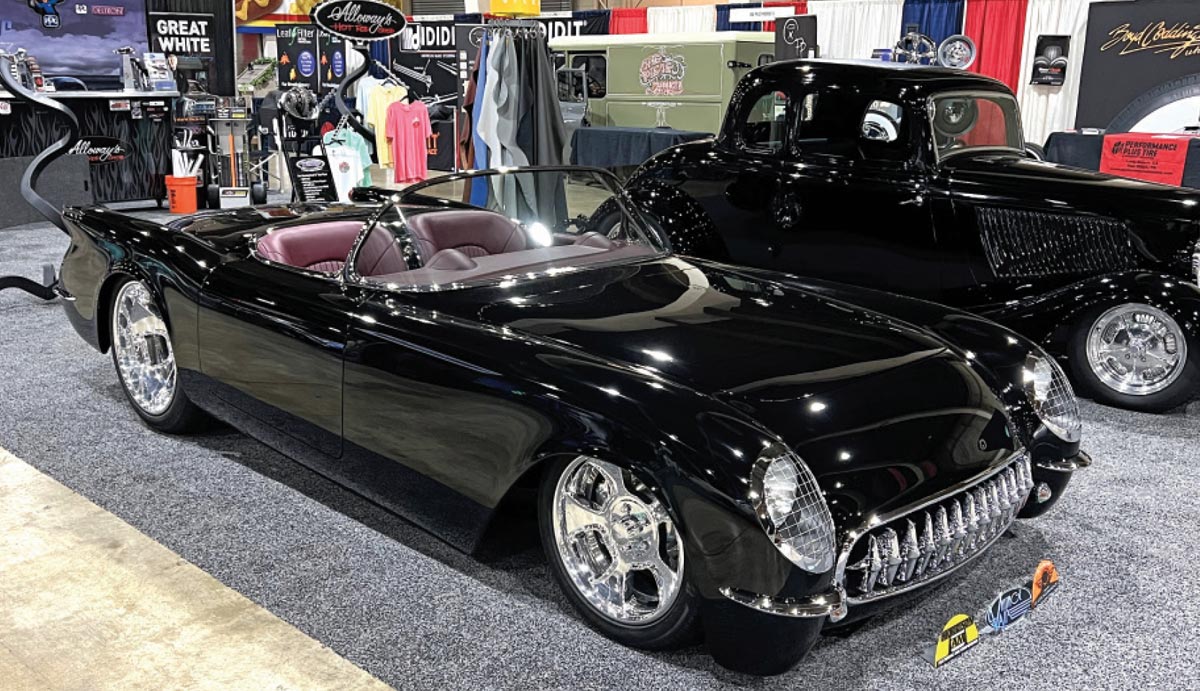 a black C1 Corvette and a black ’32 Ford five-window coupe parked beside each other at the Grand National Roadster Show