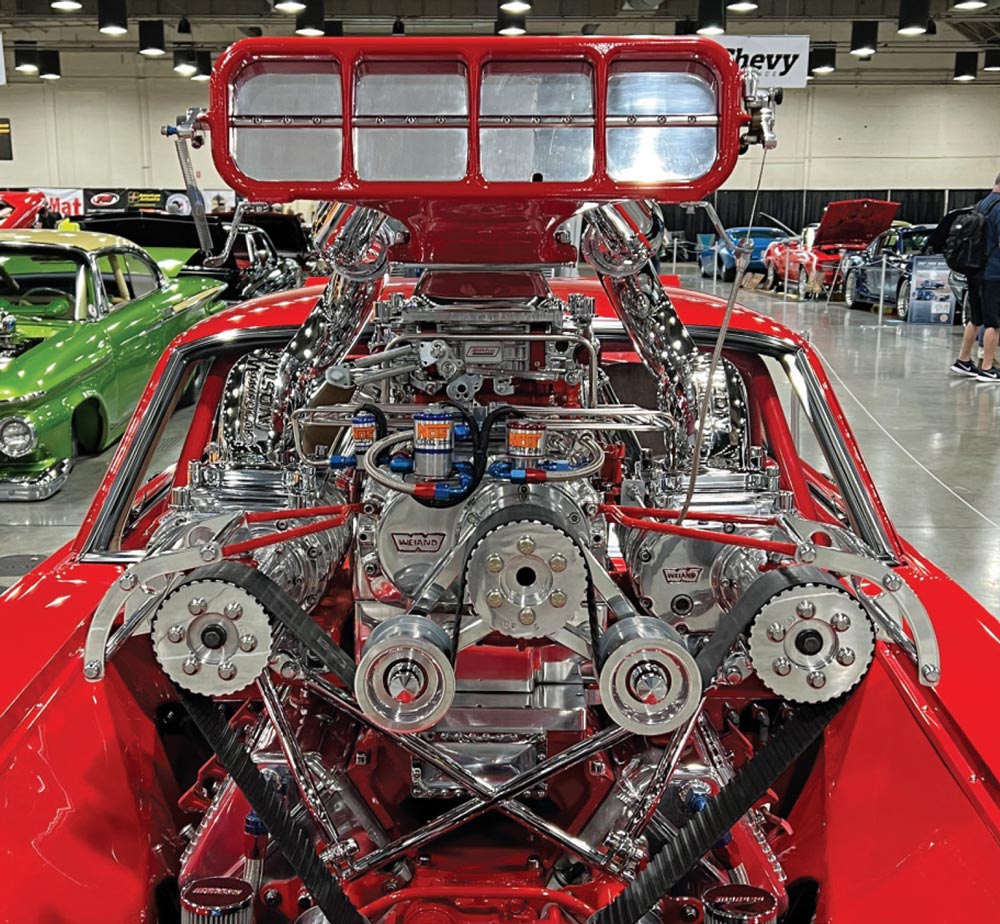 close up of the 8-71 Weiand blower and 427 LSX engine on a Porsche Red ’65 Mustang