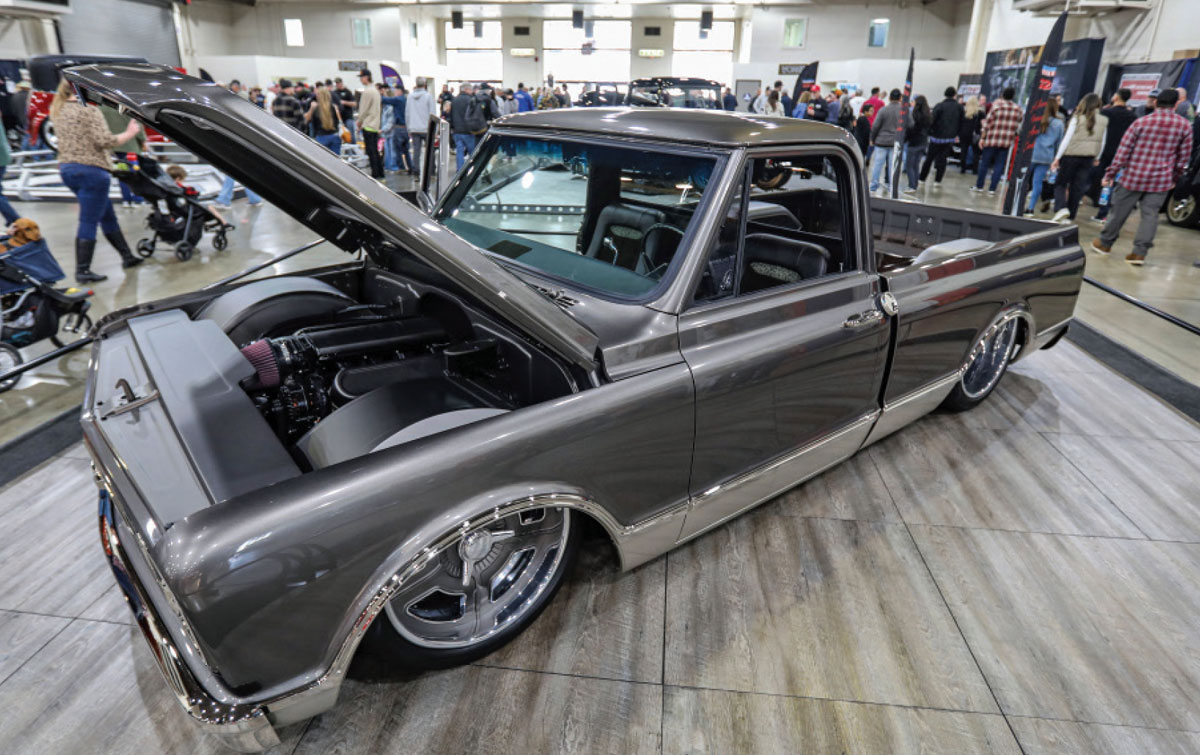 driver side of a dark silver ’67 Chevy C10 pickup with its hood lifted