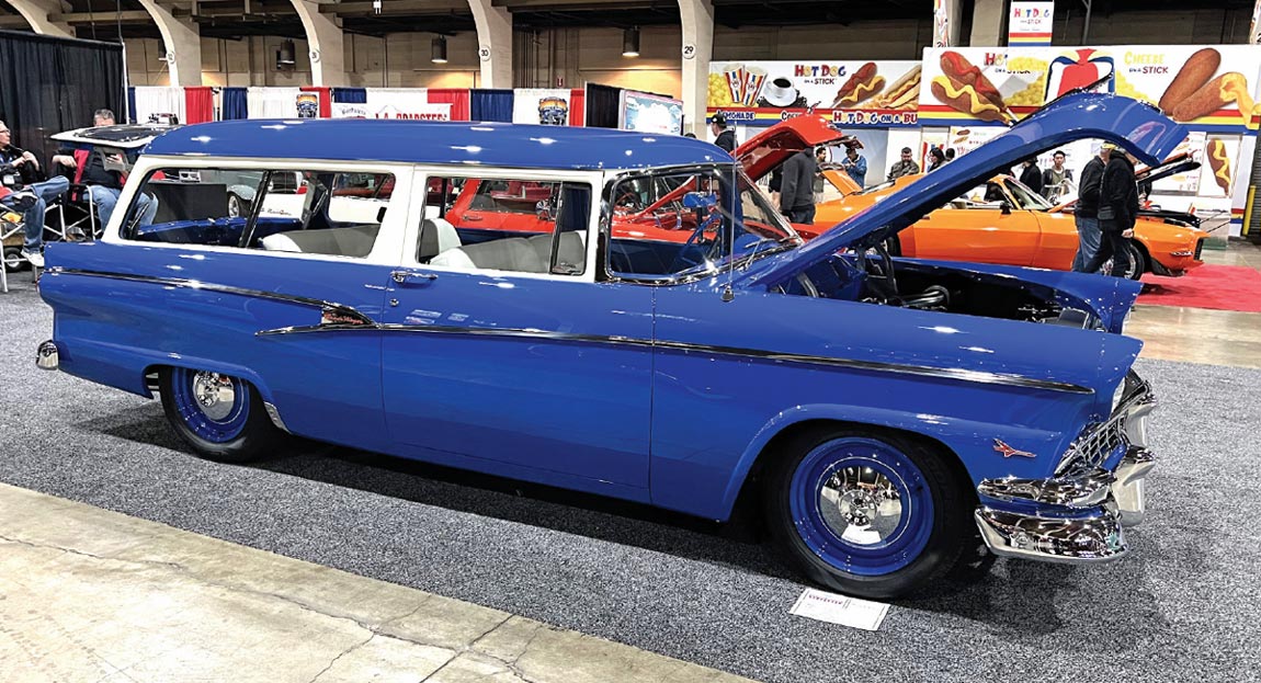 passenger side of a blue ’56 Ford Ranch Wagon with its hood and rear gate lifted