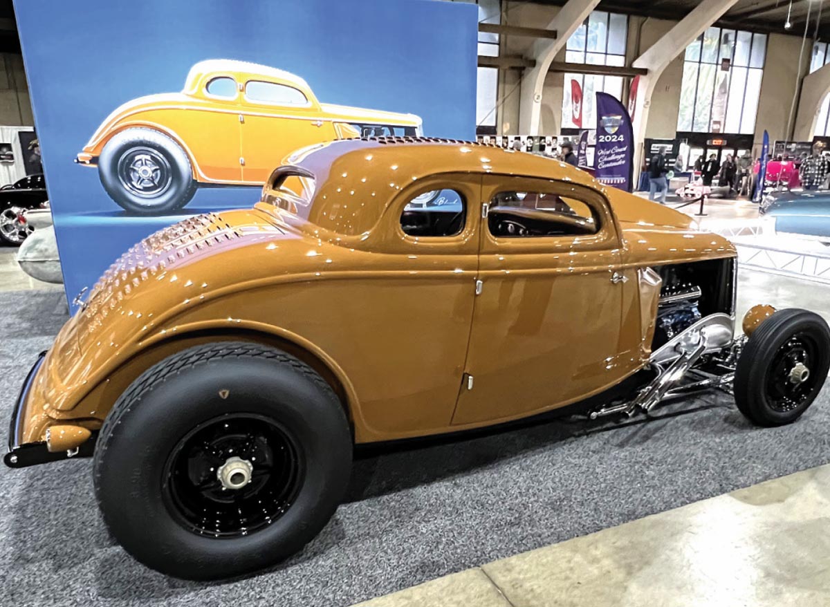 passenger side of a sand colored ’33 Ford channeled five-window coupe