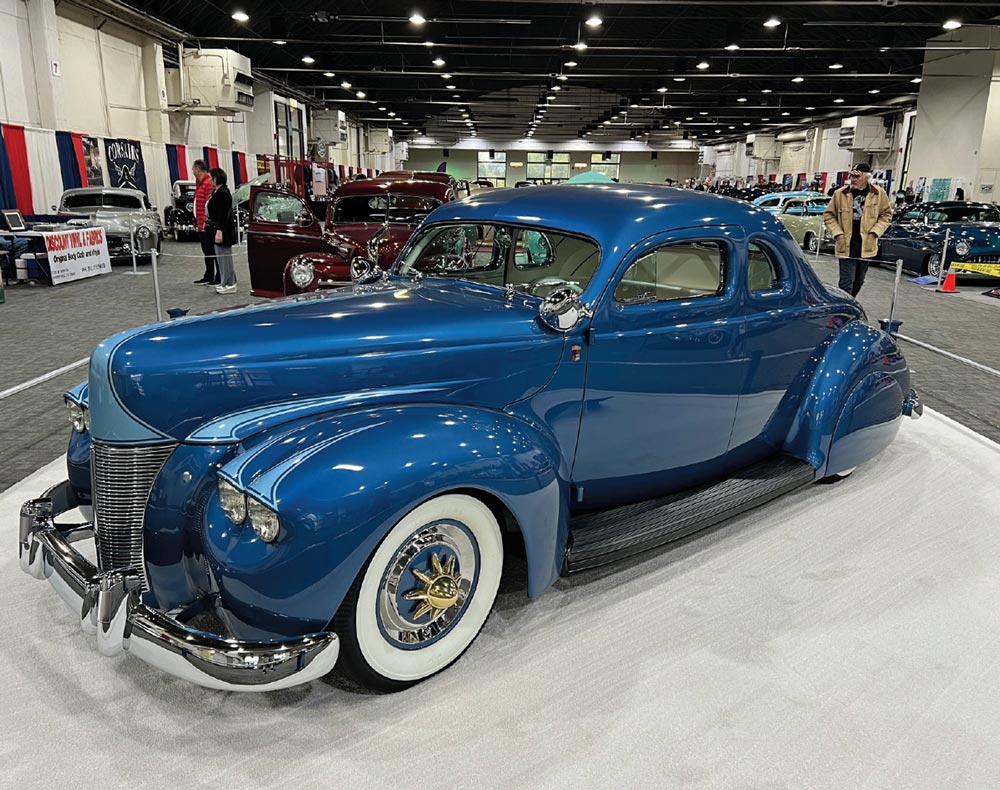 driver side of a deep blue ’40 Ford custom with light blue accents