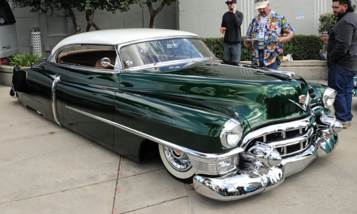 passenger side of a deep emerald green ’52 Cadillac Series 62 with a creme top