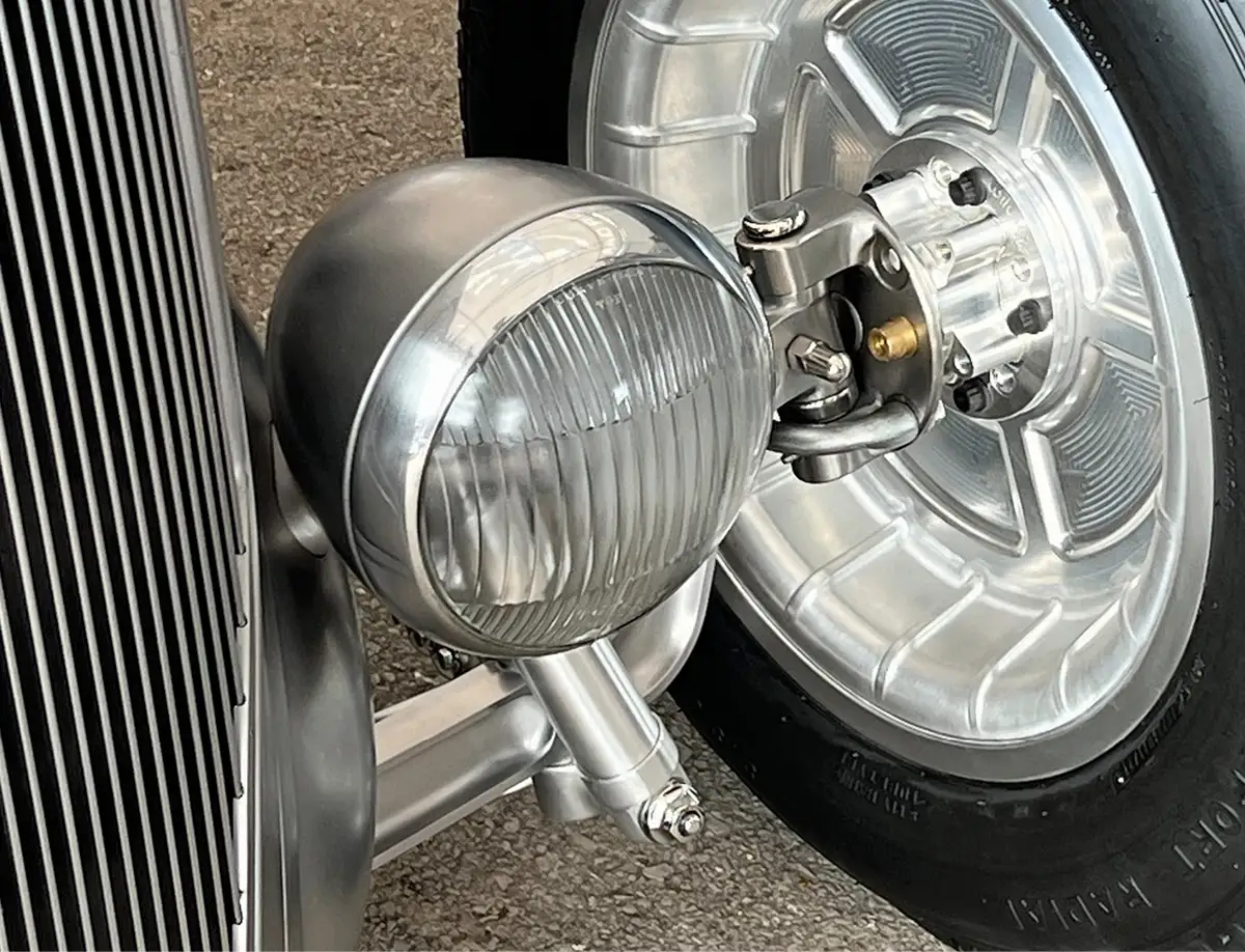 Using torsion bars instead of a leaf spring and hiding the top of the shock absorber inside the headlight gives the front of the car a very clean appearance. Custom billet wheels were specially made for this car.