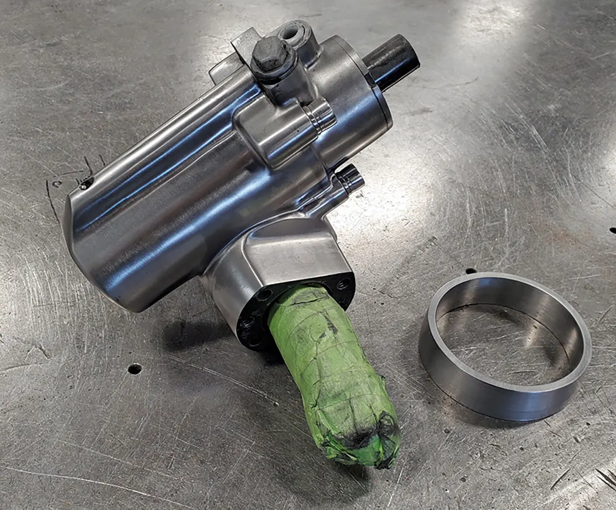 A Classic Performance Products power steering unit was painstakingly smoothed. The steel ring on the right will become part of the mount that holds the unit to the chassis.