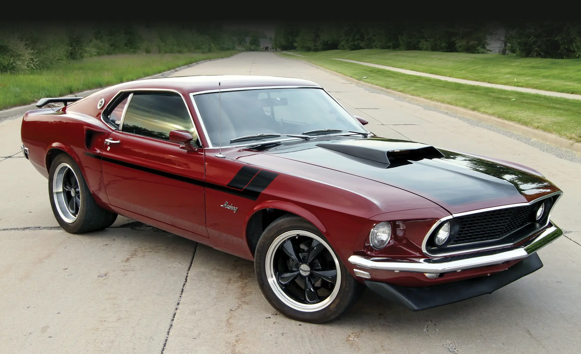 3/4 view of red and black '69 Ford Mustang
