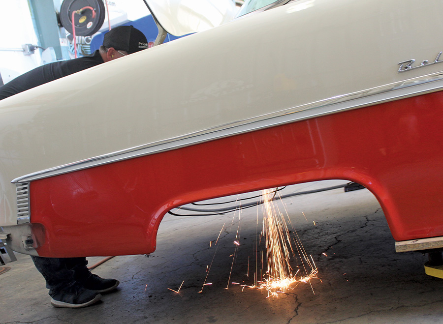 person removing the floor from the trunk area