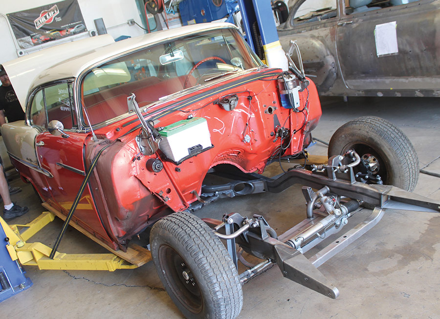 chassis being rolled underneath the original '55 Bel Air