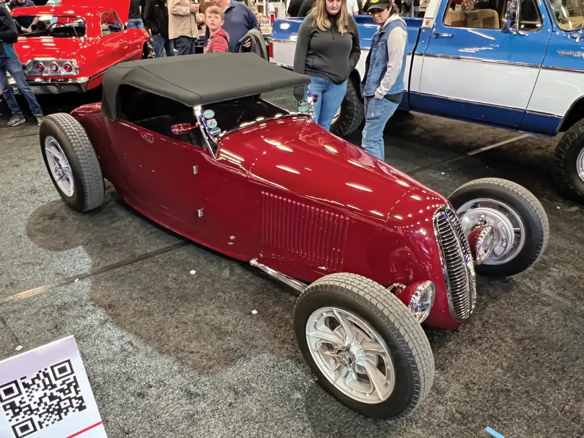 passenger side view of a flat red ’27 Ford roadster