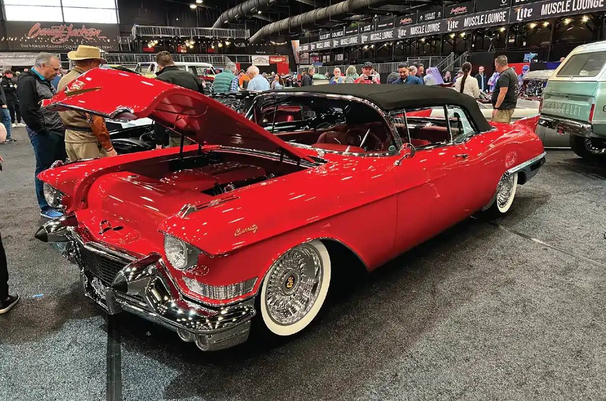 a glossy flat red ’57 Cadillac Eldorado Biarritz convertible with its hood open